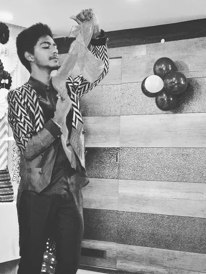 A black and white shot of me performing a silk magic routine on stage. Even simple props can create powerful moments of illusion and wonder when presented with style.
