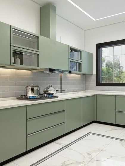 This kitchen showcases a fresh, modern aesthetic with sage green cabinetry and a white subway tile backsplash. The design includes a mix of solid and glass-front upper cabinets, a built-in chimney, and under-cabinet lighting for a bright and practical workspace.