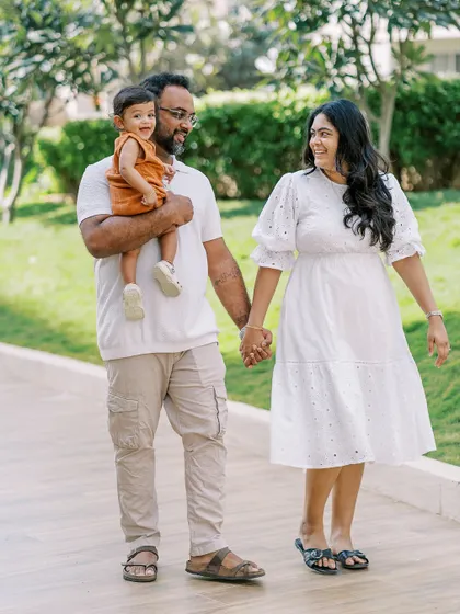 A family walking hand-in-hand. A simple, timeless shot that symbolizes their journey together.