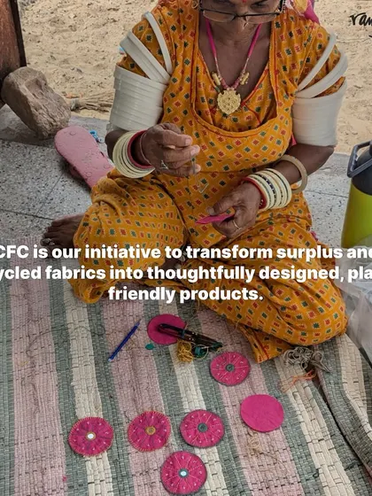 An artisan works on creating small, decorative pieces from surplus pink fabric. This is our Craft for Change initiative in action, turning upcycled materials into planet-friendly products.