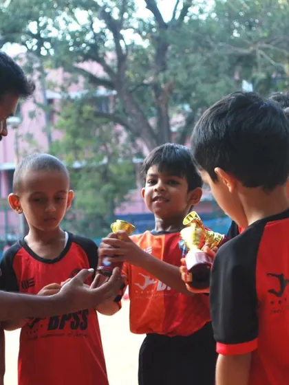 A coach hands out trophies to our toddler team. Every player's effort is recognized and celebrated here at BPSS.