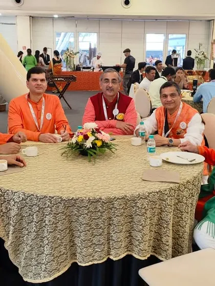 A table of distinguished guests enjoying the food and ambiance at the Vishwa Marathi Sammelan.