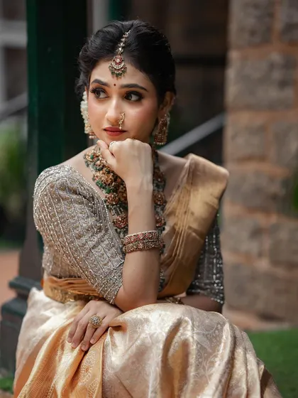A beautiful portrait of the bride looking away with a gentle smile. This is a duplicate of ID 93, focusing on her exquisite temple jewelry.