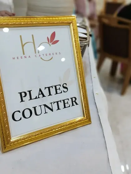 Even the plate counter is presented with elegance. A simple, framed sign helps guide guests smoothly through the dining experience.
