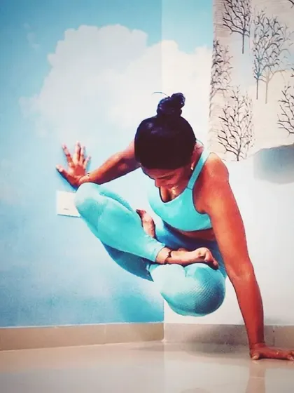 Here I'm practicing a variation of Scale Pose, or Tolasana, in a half-lotus against the wall. This builds incredible core and arm strength, preparing the body for lifting into freestanding arm balances.
