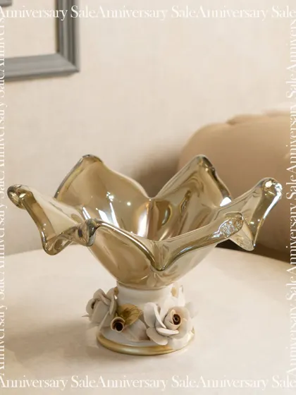 A beautiful Murano-style glass bowl, featured as part of an upcoming sale. Its floral base and delicate, flowing shape make it a piece of art that adds sophistication to any surface.