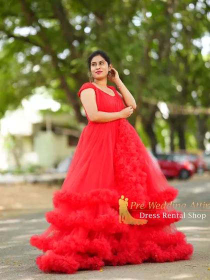 A side view of the red ruffled gown, showing the cascade of ruffles.