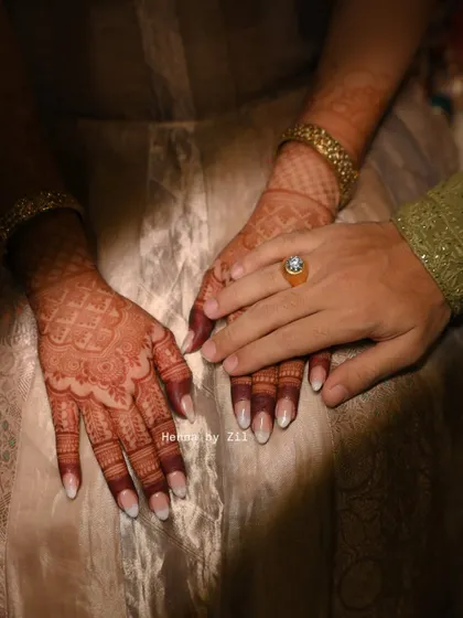 A beautiful shot of the bride and groom's hands, showing the lovely henna stain. Even the groom's simple design has a great color.