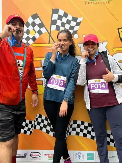 A family celebrating their 5k finish together. Running is a great activity for the whole family.