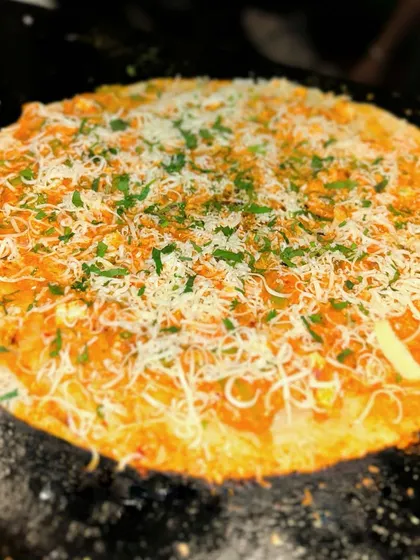 For those who like it spicy, my Peri Peri Open Dosa is a must-try. A crispy dosa is topped with a fiery peri peri sauce, melted cheese, and fresh herbs for a bold and zesty flavor combination.