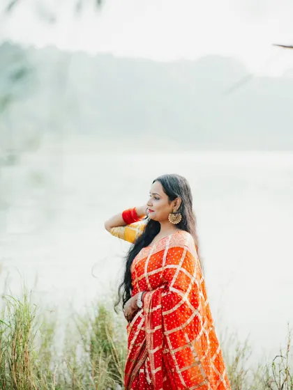 This portrait, taken by a serene lake in Jabalpur, shows a softer, more tranquil side of my work. The natural setting and the beautiful bandhani saree come together to create a timeless and graceful image.