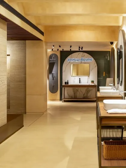 The layout of the ABC Emporio showroom uses varied vanity displays to showcase different styles. The mix of materials like stone, wood, and patinated metal creates a rich, tactile environment for customers.