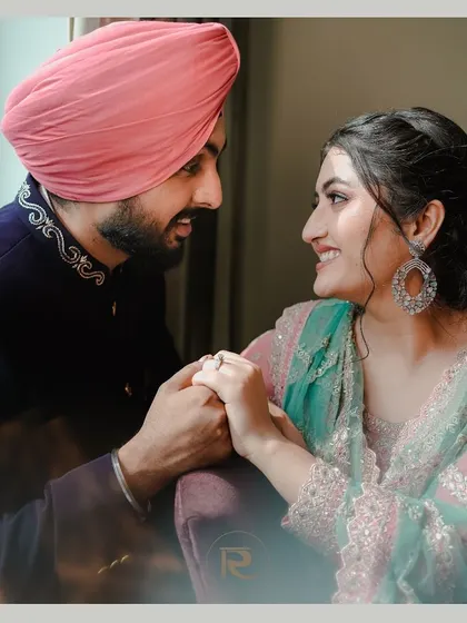 A soft and romantic portrait of a Sikh couple during their Sagan ceremony. The natural window light creates a beautiful, gentle mood.