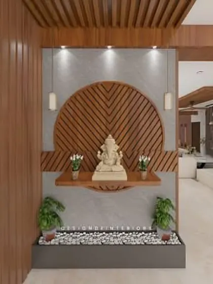 This serene entryway design features a Ganesha idol on a floating shelf against a beautifully carved wooden backdrop. The small pebble garden below adds a natural, calming touch.