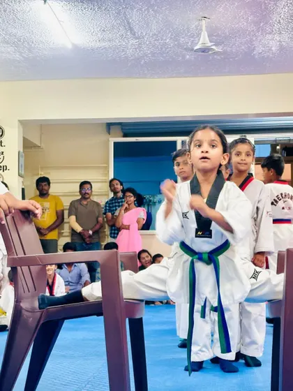 A young girl demonstrates her flexibility and focus.