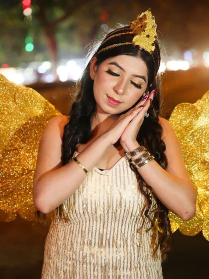 This whimsical pose adds to the fairy-tale narrative of the creative shoot, showcasing the makeup and costume details.