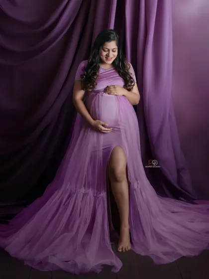 The soft lavender fabric drapes beautifully in this serene portrait. My studio sessions allow for creative use of fabrics and props to match any color palette you envision.