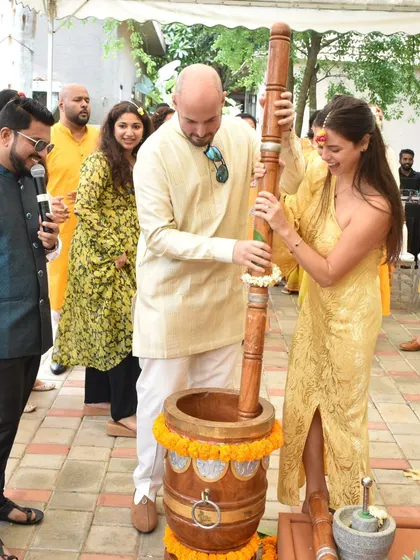 Explaining a traditional Haldi ritual to international guests. It's a joy to share our culture and see everyone participate.