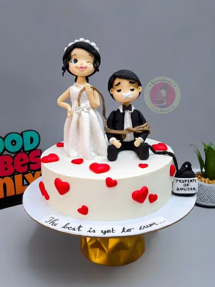 Another angle of our popular bridal shower cake, showing the "Property of" detail on the weight, adding a humorous touch.