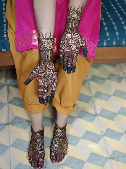 A complete set of hand and foot mehendi. The matching intricate patterns create a stunning look from head to toe.