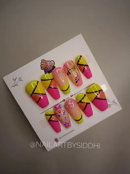 A custom press-on set designed for Ganesh Chaturthi. It features a hand-painted Ganesha portrait, vibrant colors, and geometric patterns, perfect for the festive season.
