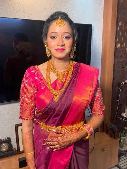 The bride looks radiant and happy, ready for her engagement ceremony. The makeup is designed to be photogenic and long-lasting for the entire event.