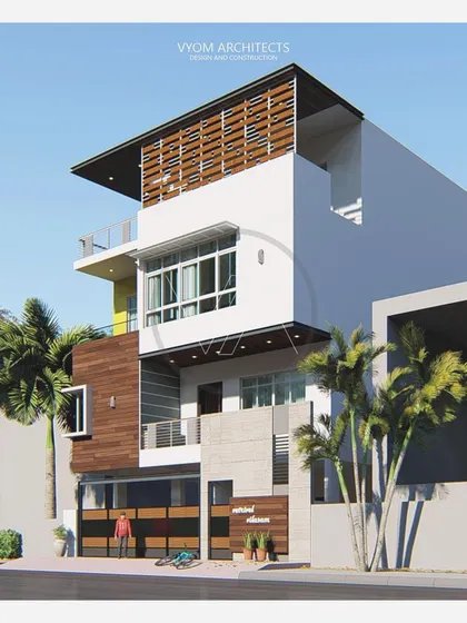 The Vishal residence in Bangalore, designed with a prominent sloped roof and a wooden screen on the top floor. The facade combines wood cladding, white walls, and concrete textures for a layered, contemporary feel.