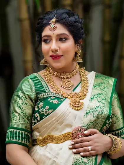 The expecting mother looks absolutely radiant. The traditional silk saree is draped to be both beautiful and practical for the baby shower ceremonies.