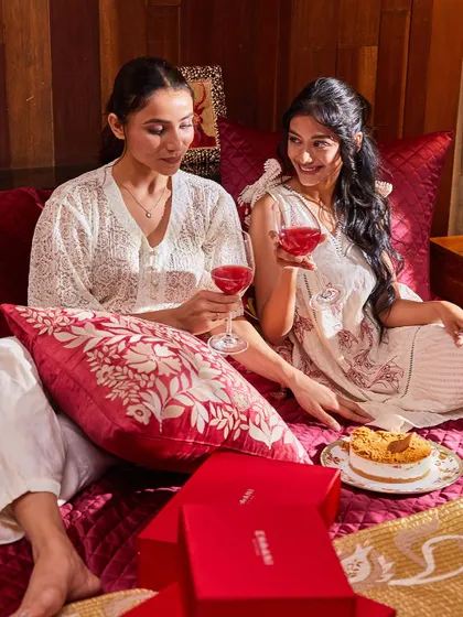 A cozy moment shared with my Anardana collection. The rich red cushion covers and elegant gift boxes create an atmosphere of warmth and luxury, perfect for an intimate celebration.