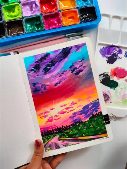 The finished "Melodious Sunset" painting in my sketchbook. I love creating these dramatic and colorful skies with gouache.