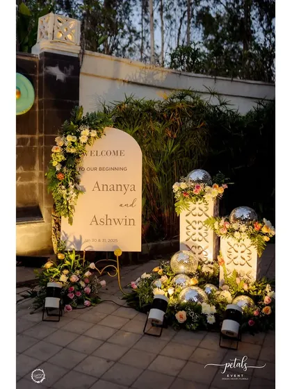 A glamorous welcome to a Sangeet night. The arched sign is flanked by floral arrangements and disco balls, immediately signaling a night of fun and celebration.