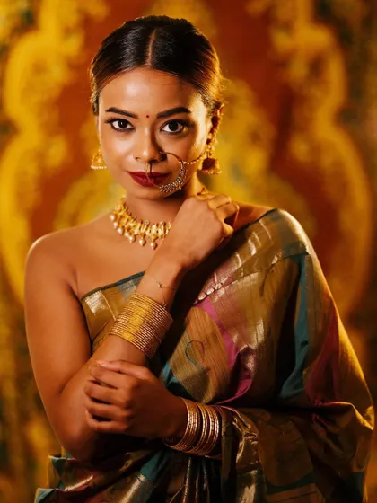 A direct and confident look from the same series. The lighting highlights the beautiful texture of the saree and the intricate jewelry.