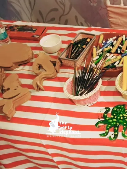 An art station where children painted wooden sea creatures like seahorses and octopuses. This hands-on activity allows for creative expression and a fun party favor.