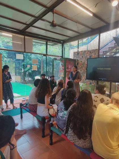 A presentation in progress for visiting university students at our puppet museum. We use visuals and interactive talks to explain the history and cultural significance of the puppets in our collection.