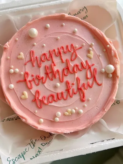 A pretty pink mini cake for a beautiful birthday girl. The simple "happy birthday beautiful" message is accented with delicate pearls and hearts for an elegant touch.