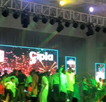 A moment of high energy on the dance floor at the Cipla event, with green lighting creating a dynamic effect.