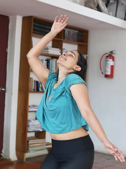 An actor in a joyful pose during a "Gretel" rehearsal.