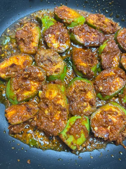 This is my raw banana roast, cooked with a bold chili paste and a cheeky umami kick. The raw banana slices are pan-fried until they have the perfect texture, with the fiery masala clinging to every piece.