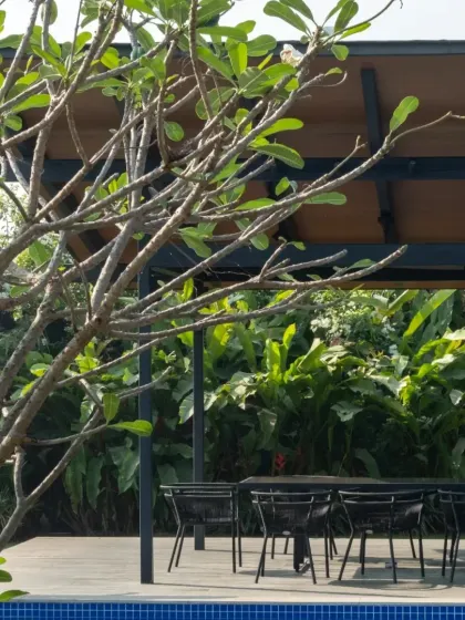 An outdoor dining pavilion by the pool in Alibaug. These spaces are central to our country homes, blurring the line between inside and out and encouraging a life lived in connection with nature.
