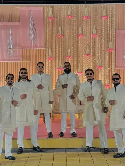 Ready for a baraat in Jaipur. Our coordinated off-white outfits add a touch of class and unity to our performance.