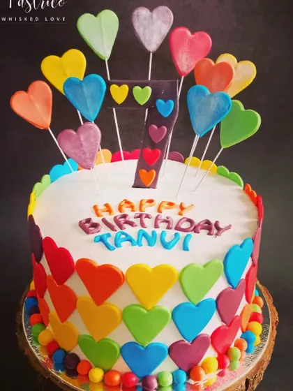 A vibrant cake covered in rainbow hearts, perfect for a colourful and love-filled 7th birthday.