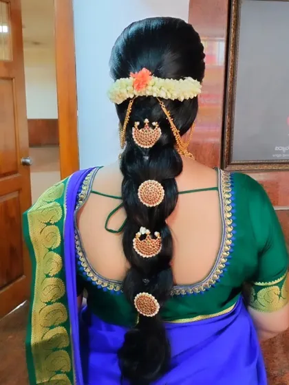 A bubble braid where each section is adorned with a traditional gold billai, perfect for a temple wedding look.
