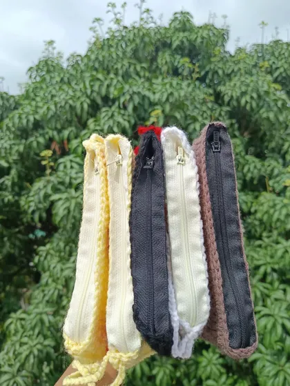 Showing the inside of my crochet pouches, which are lined and feature a secure zipper closure to keep belongings safe.