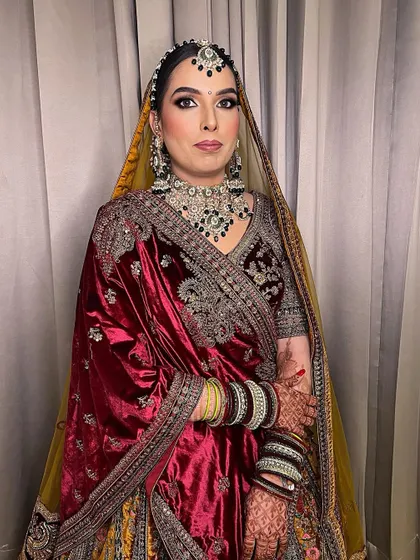 A full view of this sweet bride in her bridal glory. The makeup is designed to be both elegant and long-lasting, perfect for a winter wedding.
