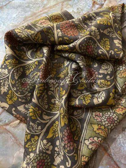 This shot captures the soft sheen of the silk and the meticulous detail of the hand-painted vines and flowers, a testament to the artisan's skill.