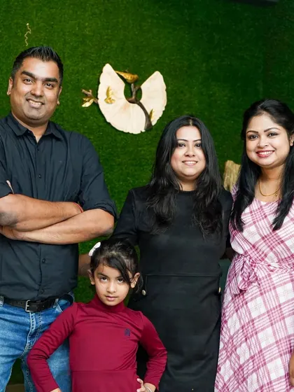 A family with their young daughter enjoying an evening out. It's a place where memories are made for everyone.