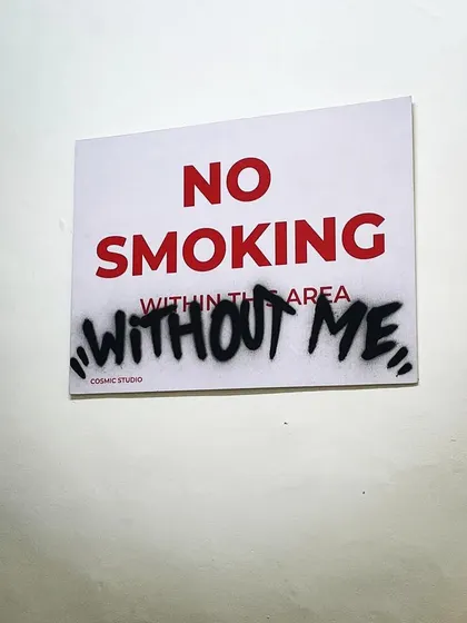 A fun, custom touch I added to the studio space. This "No Smoking" sign was modified with a graffiti tag to say "No Smoking Without Me," adding to the studio's rebellious and playful vibe.