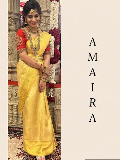 A full-length view of this classic South Indian bridal look. The contrast of the red embroidered blouse against the yellow Kanjivaram is timeless.