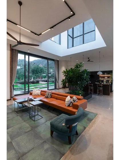 This is a duplicate of ID 71. The living room of the Nandi Hills home is designed around sightlines to the outdoors.