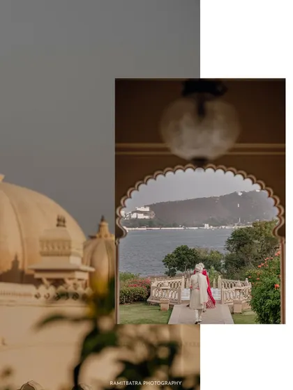 A creatively framed shot of a couple at The Oberoi Udaivilas, seen through an archway with the lake and palace in the background.